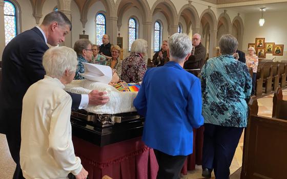 Pallbearers accompany the casket of Bishop Thomas Gumbleton.