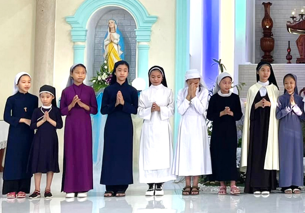 Children model the habits of nine women congregations at Loc Tien Church in Phu Loc district of Thua Thien Hue province, Vietnam, April 27. "The event aims at orientating youths to religious vocations so that they can choose and join them later," said St. Paul de Chartres Sr. Lucia Ho Thi Thuy, a member of the vocation promotion committee of the Women Orders Association, which held the event. (Joachim Pham)
