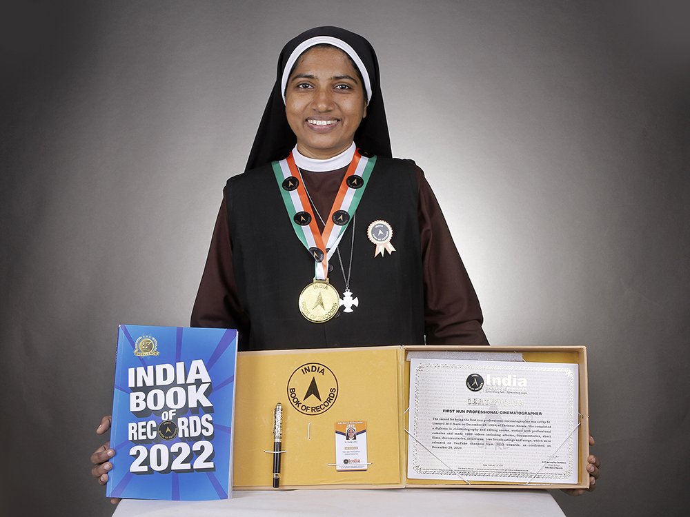 Carmelite Sr. Lismy Parayil, who was listed in the India Book of Records as the first cinematographer nun in India, shows her award and citation. (Courtesy of Sr. Lismy Parayil)