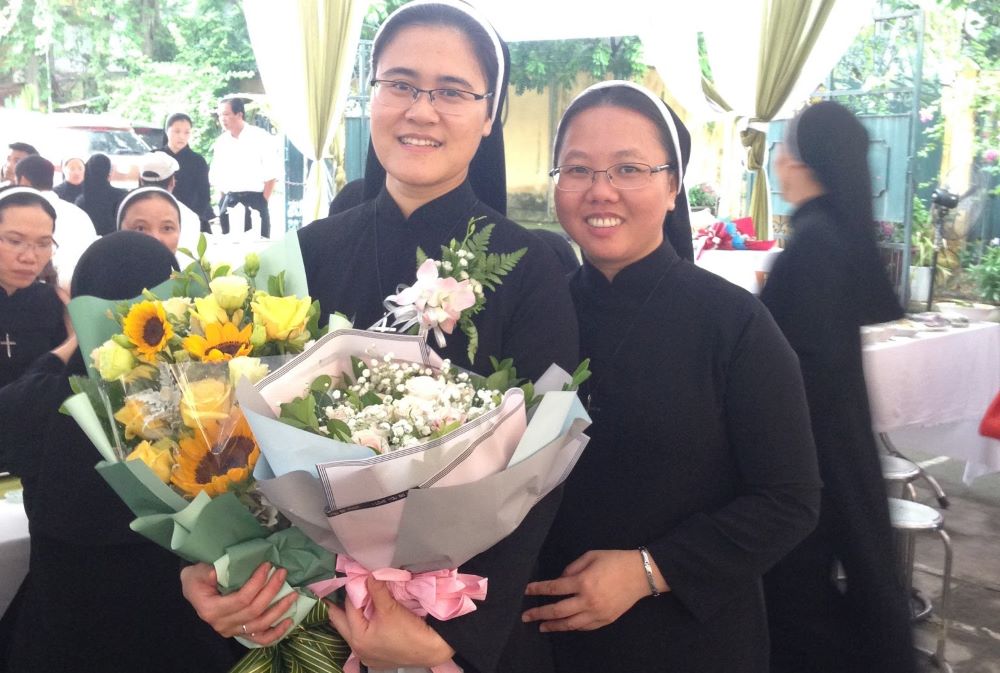 Sr. Ngoc Nguyen made her perpetual vows with the Congregation of the Lovers of the Holy Cross in Vietnam at St. Joseph Cathedral in the Diocese of Hanoi on Aug. 1, 2019. At right is Sr. Yen Le. (Courtesy of Ngoc Nguyen) 