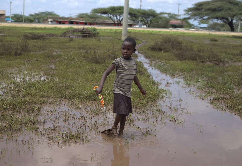 A child walking through the flooded water in Samburu, northern Kenya, on Nov. 9. (GSR photo/Doreen Ajiambo)