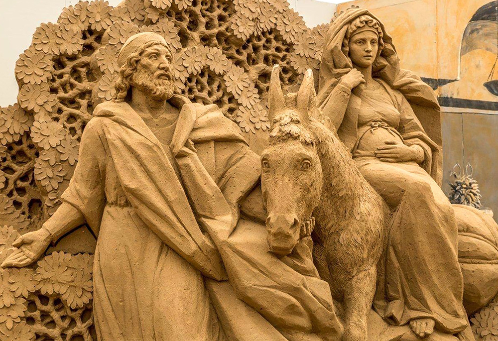 A depiction of Mary and Joseph's journey to Bethlehem sculpted from sand is displayed in the Italian resort town of Jesolo. (CNS/Jesolo Tourism Office)