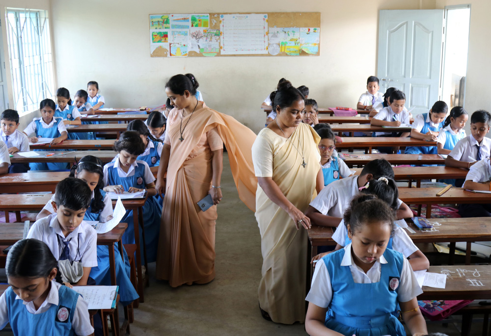 Our Lady of the Missions Sr. Pronoti Costa and Sr. Shongita Gomes proctor at an examination hall at St. Martha's High School at Sreemangal, Moulvibazar District, in Bangladesh. The congregation built the school and a hostel for girls of the Khasi ethnic group and for girls of workers from the area's tea gardens. (Stephan Uttom Rozario)