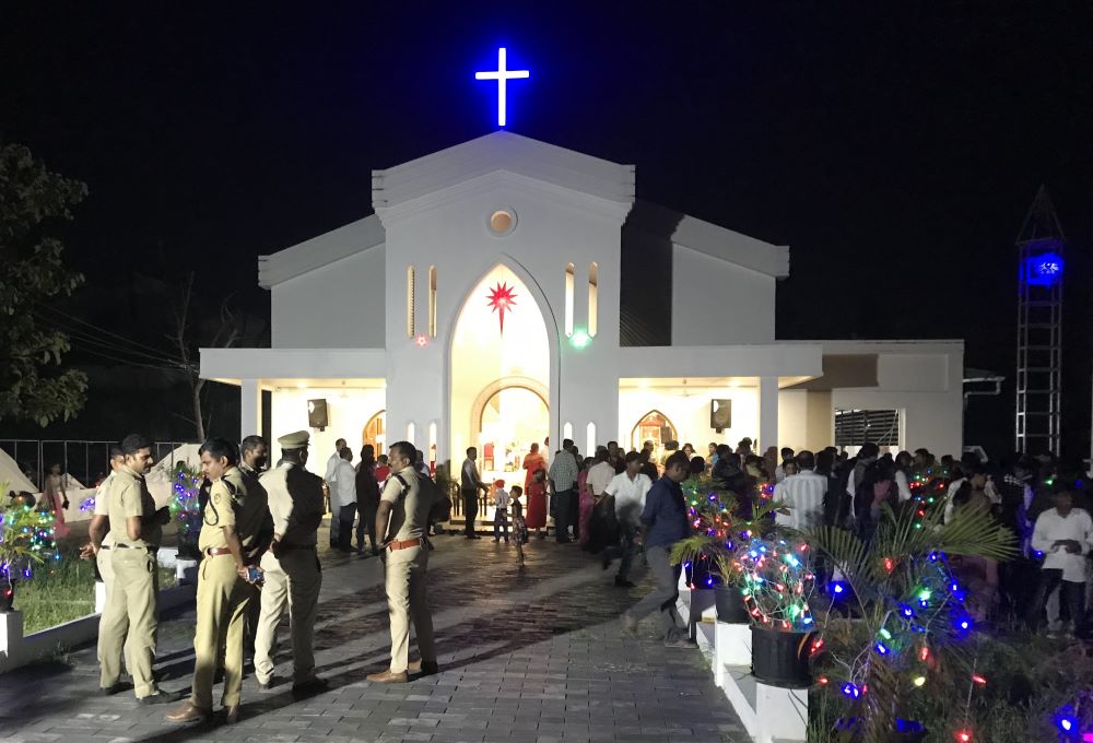 	Police officers stand outside St. Thomas Church, Chittoor, on the outskirts of Kochi, Kerala, during the Christmas midnight Mass as protesters demanded the synodal Mass. (Thomas Scaria)