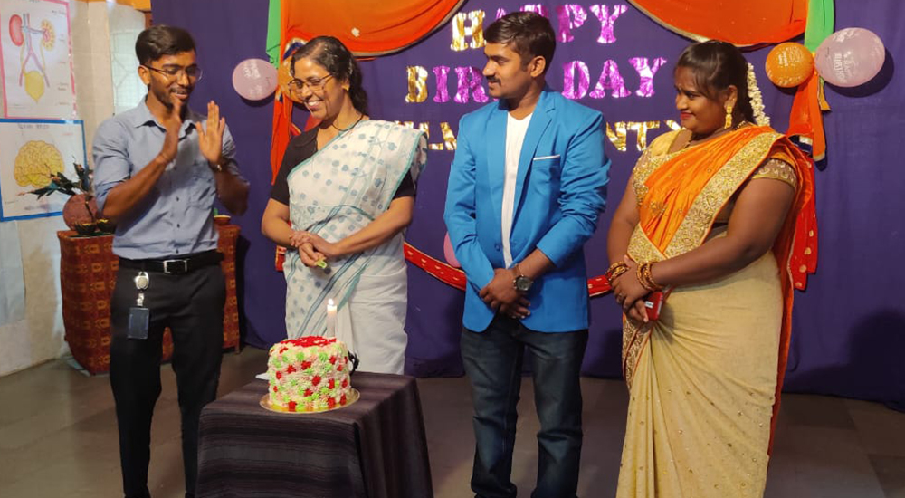 The staff of BOSCO Yuvakendram Bengaluru, southern India, hold birthday celebrations for Silvy Lawrence Pazherickal and a former boy of the center, Deepu, wearing blue, Sept. 21, 2021. (Provided by Silvy Lawrence)