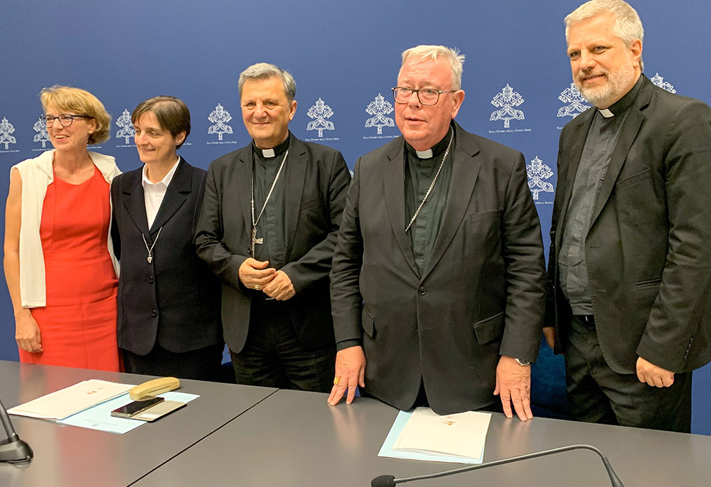 The people who presented the working document for the Synod of Bishops pose June 20, 2023, at the Vatican press office. From the left are Helena Jeppesen-Spuhler, a synod participant from Switzerland; Sr. Nadia Coppa, president of the women's International Union of Superiors General; Cardinal Mario Grech, synod secretary-general; Cardinal Jean-Claude Hollerich, synod relator general; and Jesuit Fr. Giacomo Costa, a consultant to the synod. (CNS/Cindy Wooden)