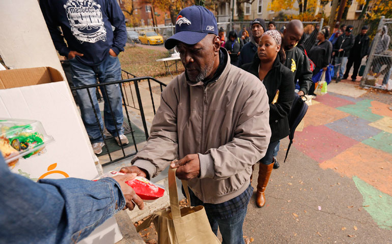 A man receives food at the Southeast Neighborhood House food bank in Washington, D.C., Nov. 20, 2012. (Reuters/Kevin Lamarque)
