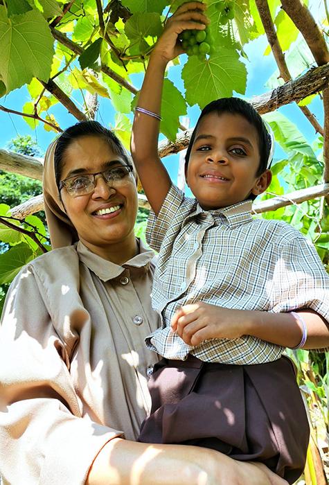 Franciscan Sisters Servants of the Cross Sr. Mary Clare with Sahana, a resident of Jyothi Seva, during an educational trip to a vineyard in Bengaluru, southern India (Courtesy of Sr. Mary Clare)
