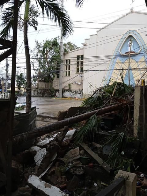 Fallen trees on top of the rubble of the gate of the convent of the Missionary Sisters of Mary in Lapu-Lapu City, Cebu province. (Courtesy of Missionary Sisters of Mary)
