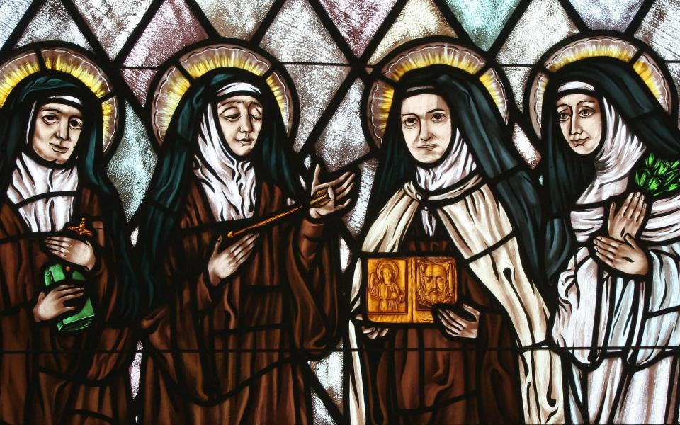 Sts. Edith Stein, Teresa of Ávila, Therese of Lisieux and Catherine of Siena are represented in stained glass at St. Thérèse of Lisieux Church in Montauk, N.Y. (CNS photo/Gregory A. Shemitz, Long Island Catholic)