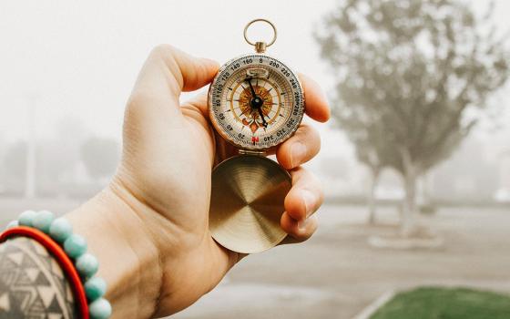 Hand holding a compass (Unsplash/Frames For Your Heart)