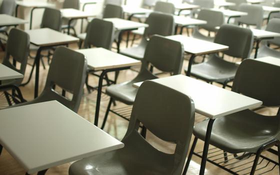 Rows of school desks and chairs (Unsplash/MChe)