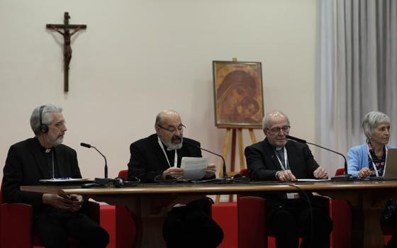 Fr. Tomas Halik, second from left, speaks at a meeting of parish priests as part of the ongoing process for the Synod of Bishops April 29 at Sacrofano, outside of Rome. Other speakers at the table, from left, are: Bishop Luis Marín de San Martín, synod undersecretary; Canadian Fr. Gilles Routhier; and María Lía Zervino, sociologist and former president of the World Union of Catholic Women's Organizations. (CNS/Courtesy of the Synod of Bishops)