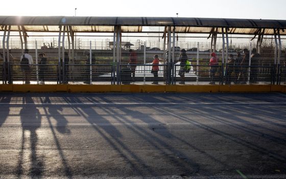 People authorized to cross the U.S.-Mexico border line up on the U.S. side of the McAllen-Hidalgo-Reynosa International Bridge early in the morning of March 22 in McAllen, Texas. (Nuri Vallbona)