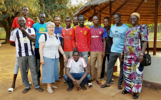 Sr. Joan Mumaw, standing front, with Sr. Esperance Bamiriyo, principal of the Catholic Health Training Institute in Wau, South Sudan, and a Comboni Missionary Sister, right, with 2019 graduates of the institute (Courtesy of Solidarity with South Sudan)