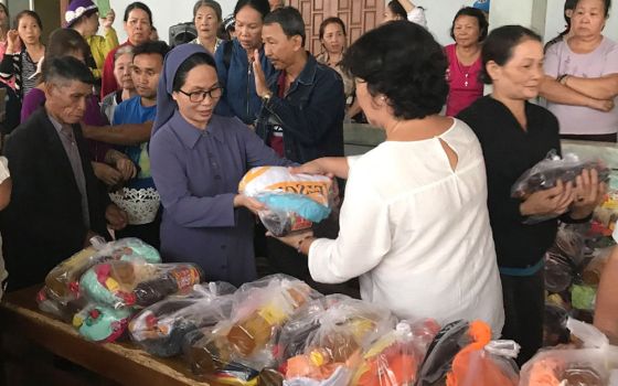 Sr. Maria Goretti Le Thi Van Anh of the Lovers of the Holy Cross gives gifts to people in need to celebrate the Tet festival Feb. 4 in Vietnam. (Joachim Pham)