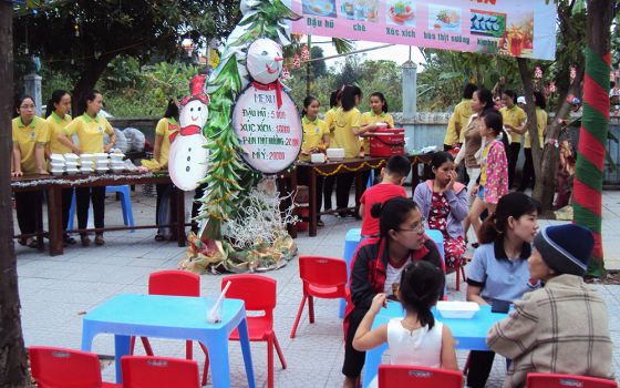 Lovers of the Holy Cross nuns hold a "Christmas market" serving food with budget prices to local people on Dec. 12 at Pho Thach Parish in Phong Dien District of Thua Thien Hue Province, Vietnam. (Peter Nguyen)
