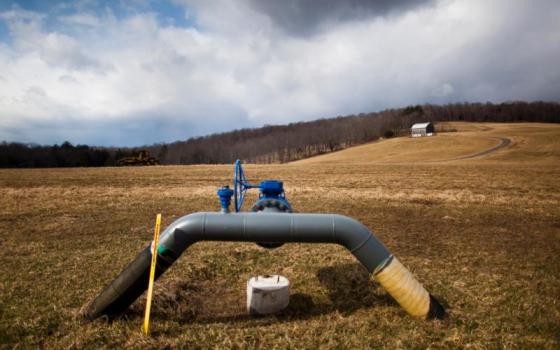 A gas pipeline juts from the ground at a farm near Dimock, Pa., in this 2012 file photo. Atlantic Sunrise is proposing to run a similar pipeline for natural gas through property owned by the Adorers of the Blood of Christ religious congregation in Columbia, Pa. (CNS/Jim Lo Scalzo, EPA)