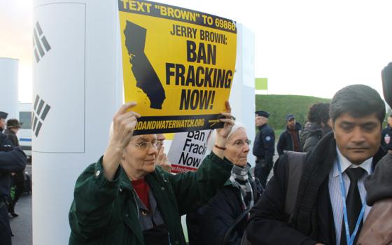 Nuns protest at an anti-fracking rally outside the main venue of COP21 Dec. 9 in Le Bourget, France. (NCR photo/Brian Roewe)