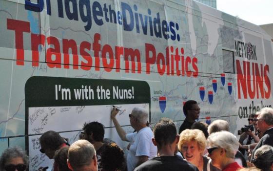 After the inaugural rally to begin the 2015 Nuns on the Bus tour, people were invited to sign their names in support of its goals. (GSR photo/Dawn Cherie Arajuo)