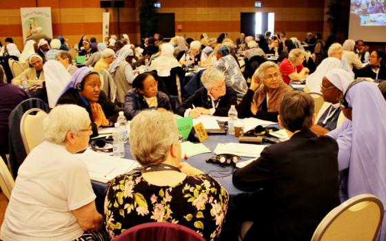 Sisters talk with their tables between presentations May 8 at the International Union of Superiors General's plenary assembly in Rome. (Courtesy of UISG)