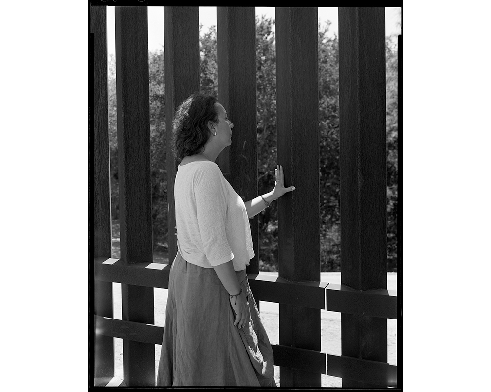 Carmen Seleme McDermott, who volunteered with Elmaleh at the Humanitarian Respite Center for migrants in McAllen, takes a break from sorting clothes at the center to visit the wall with sisters in Hidalgo, Texas. McDermott, who works at St. Joseph Parenti