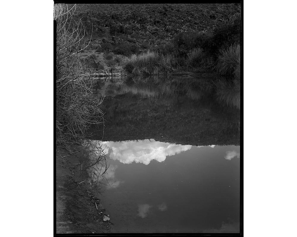 The Rio Grande in Big Bend Ranch State Park between Lajitas and Presidio, looking at Mexico. Elmaleh recalls the "oppressive heat" and how she was told by someone nearby that they had recently found a hiker dead, not uncommon for the area. "Puts into pers