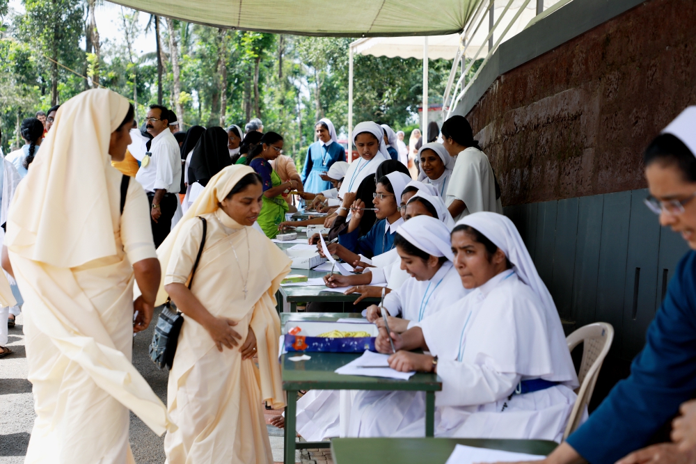 Catholic nuns register their names for a prayer gathering to address negative media coverage of religious life on Sept. 15 at the Pastoral Centre of Dwaraka parish in Kerala, India. (Saji Thomas)