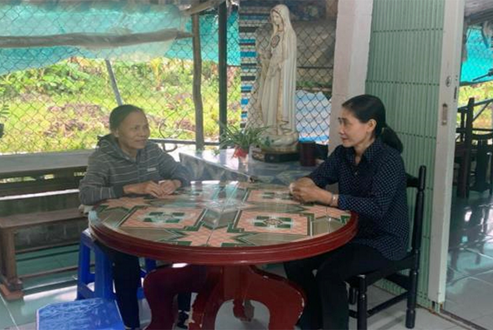 Sr. Mary Nguyen Thi My, left, meets with Sister Chuong of the Daughters of the Mother of God, about a report for a project on water purification. Since 2000, Sr. Mary Nguyen Thi My has worked with Vietnamese sisters, using her knowledge of English to help Sr. Mary Nguyen Thi My, left, meets with Sister Chuong of the Daughters of the Mother of God, about a report for a project on water purification. Since 2000, Sr. Mary Nguyen Thi My has worked with Vietnamese sisters, using her knowledge of English to help