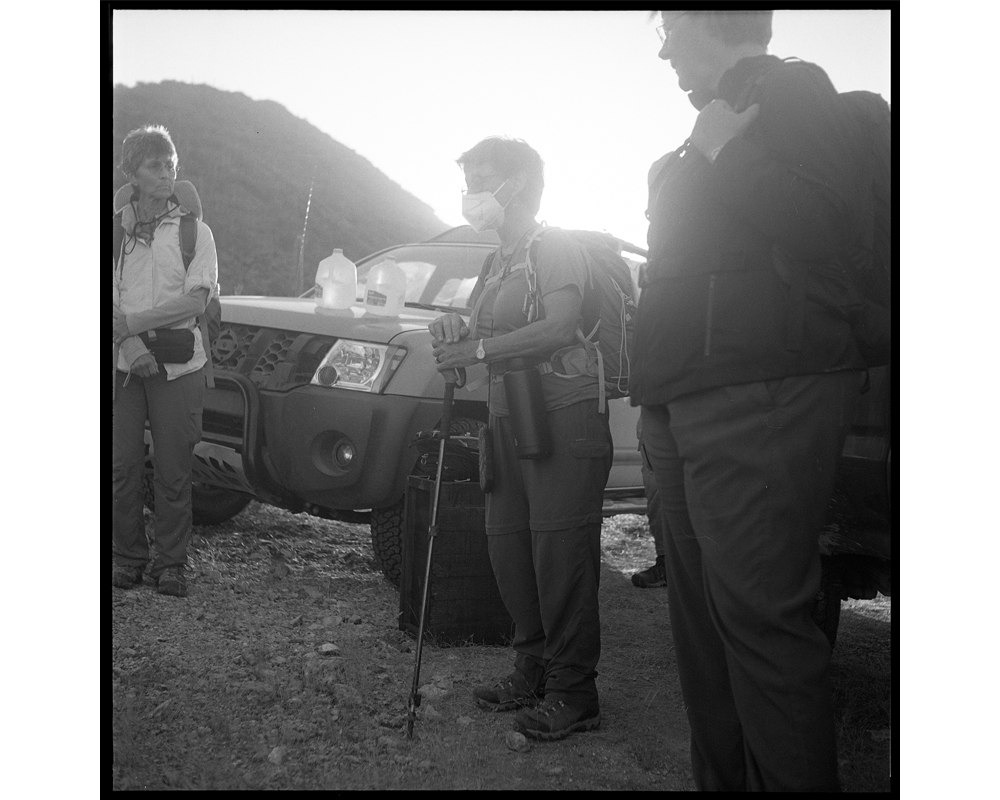 Before heading out for an arduous hike in the desert with water and food supplies, Ajo and Tucson Samaritans huddle together to plan the drop-off activities for the day. 