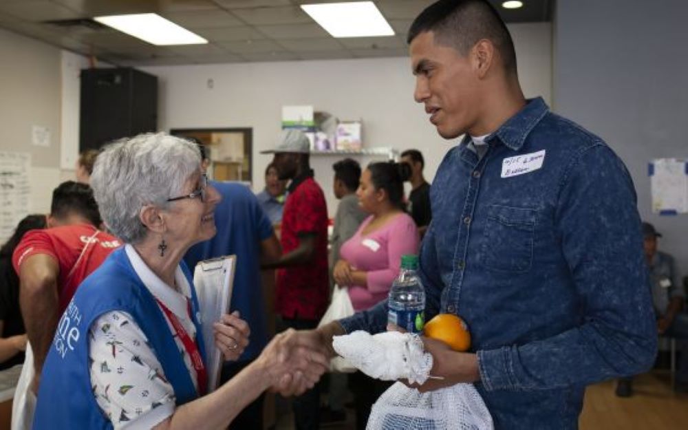Presentation of the Blessed Virgin Mary Sr. Sharon Altendorf, left, says goodbye to Jader Reyes of Nicaragua, after she gave him food and mapped his travel itinerary on June 14, 2019.