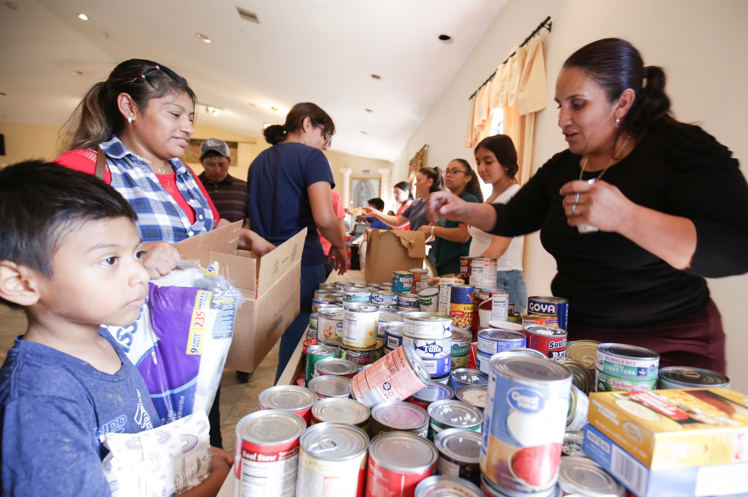 Volunteers and members of the local community distribute food at Jesús Obrero (Jesus the Worker) Parish in Fort Meyers, Florida, on Oct. 4 amid the aftermath of Hurricane Ian. (CNS/Tom Tracy)
