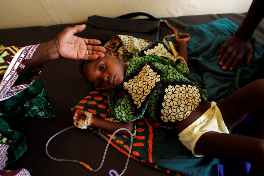 Two-year-old Aissata Dia is treated for malnutrition and malaria June 3, 2012, at a nutrition center run by the aid group Action Against Hunger in the Guidimakha region of Mauritania. (CNS/Reuters/Susana Vera)
