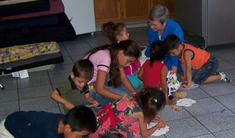 Sr. Rosemary Nicholson helps children make animal masks at Madre Asunta in Tijuana, Mexico. She has worked at Instituto Madre Asunta, a shelter for migrants across the border from San Diego, since summer 2018. (Courtesy of Rosemary Nicholson)