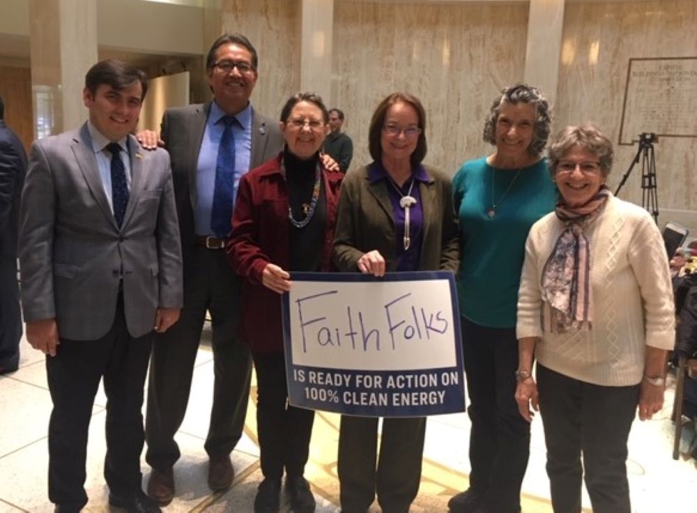 Franciscan Sr. Joan Brown, third from left, and other representatives of New Mexico Interfaith Power & Light celebrate the passing of state energy transition legislation with state Sen. Mimi Stewart, fourth from left, at the capitol in Santa Fe in 2019