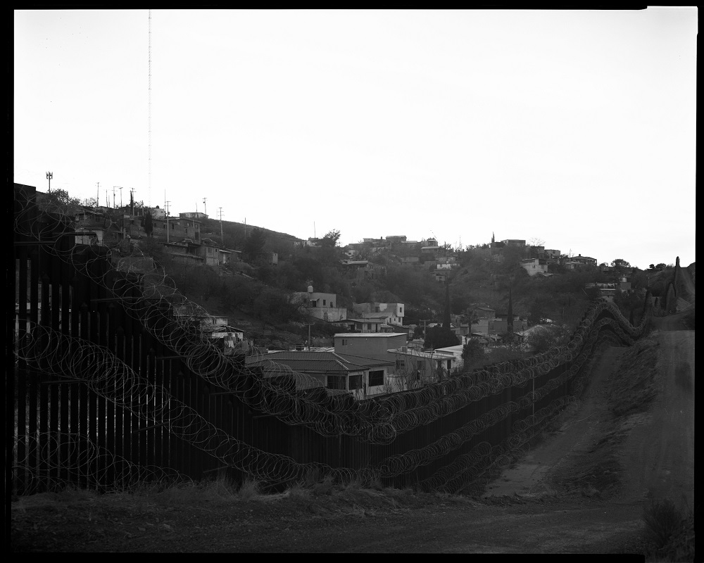The community of Nogales, Mexico, as seen over the Arizona border fence in January. The city utilizes every inch of its side of the wall. (© Lisa Elmaleh)