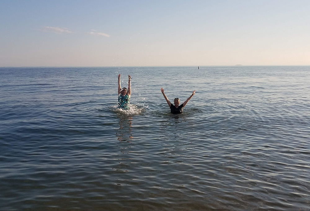 Dominican of Peace Sr. Ana Gonzalez, left, and Lovers of the Holy Cross Sr. AnHoa Nguyen enjoy the water of the Long Island Sound at Hammonasset Beach State Park in Madison, Connecticut, in summer 2020. (Provided photo)