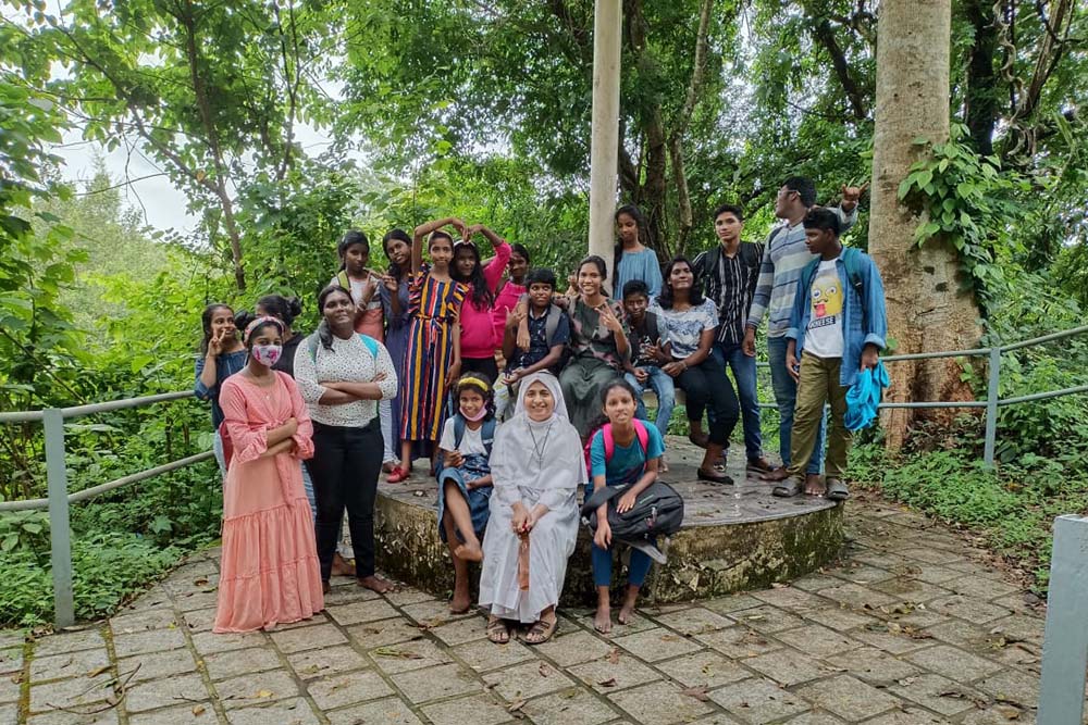 Sr. Soumitha Chittilappilly of the Sisters of the Destitute sits in front with children of Udaya Colony during a field trip in Kochi city in Kerala, India. (Courtesy of Soumitha Chittilappilly)