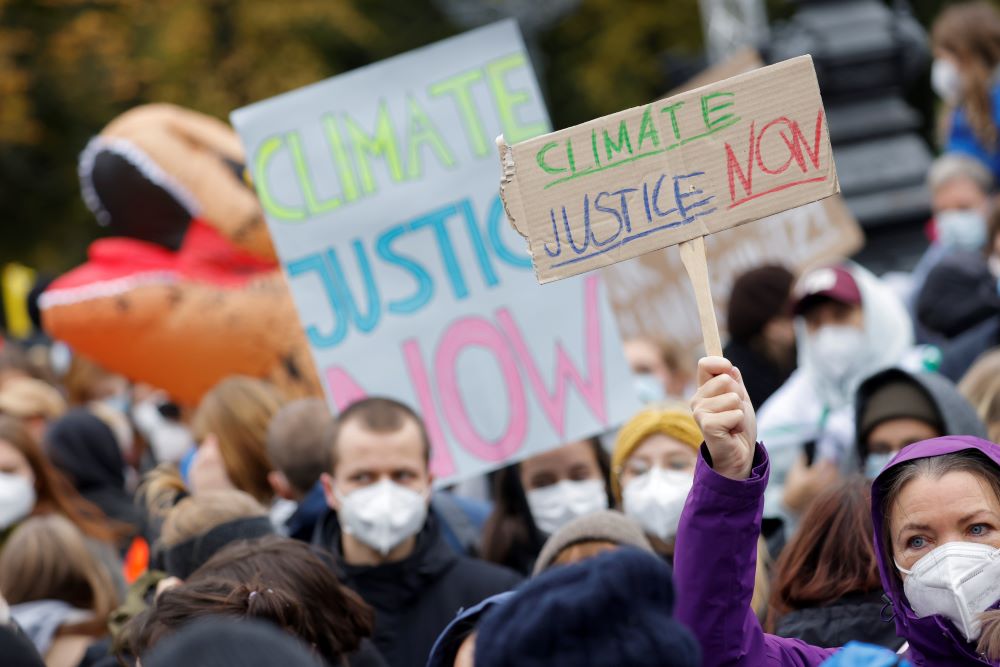 Demonstrators hold signs Oct. 22 during the Global Climate Strike of the movement Fridays for Future in Berlin. (CNS/Reuters/Michele Tantussi)