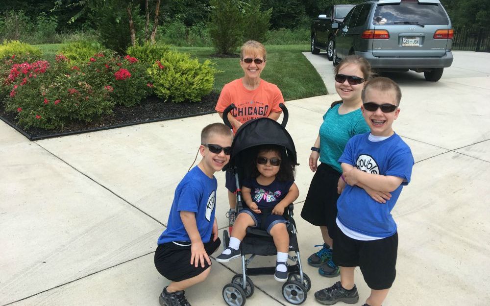 Robin Worley, in the orange shirt, with her four children, Teagan, Heidi and identical twins Micah and Noah.