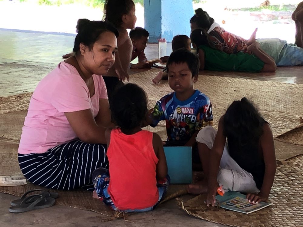 Sr. Taabeia Ibouri reads with students at the Good Samaritan Early Childhood Centre at Abaokoro, a government-registered center. (Courtesy of Meg Kahler)