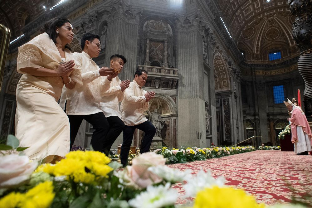 Members of the Filipino community in Rome approach the altar in the Vatican's St. Peter's Basilica during the offertory procession Dec. 15, 2019, as Pope Francis celebrates the first of the Simbang Gabi. (CNS/Vatican Media)