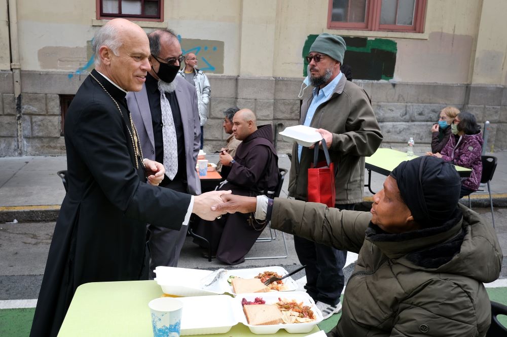 San Francisco Archbishop Salvatore J. Cordileone speaks with patrons during a visit to St. Anthony's Dining Hall in San Francisco's Tenderloin district Nov. 6. Cordileone has revealed he is not vaccinated for COVID-19. (CNS/David Maung)