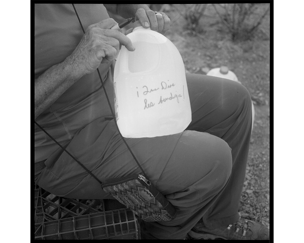 Messages are written on the water bottles left, wishing the migrants blessings and luck. (Lisa Elmaleh)