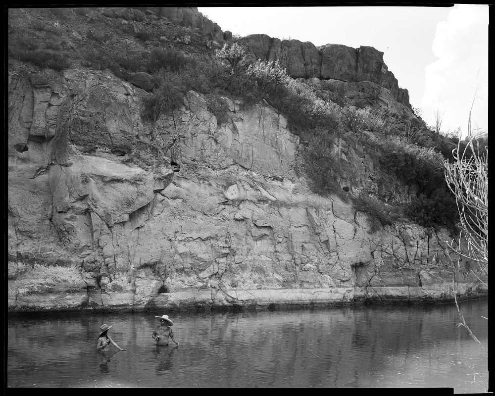 All along the Rio Grande, people enjoy the water and go for swims. Here are two individuals in Big Bend Ranch State Park; the cliff behind them is Mexico. (© Lisa Elmaleh)