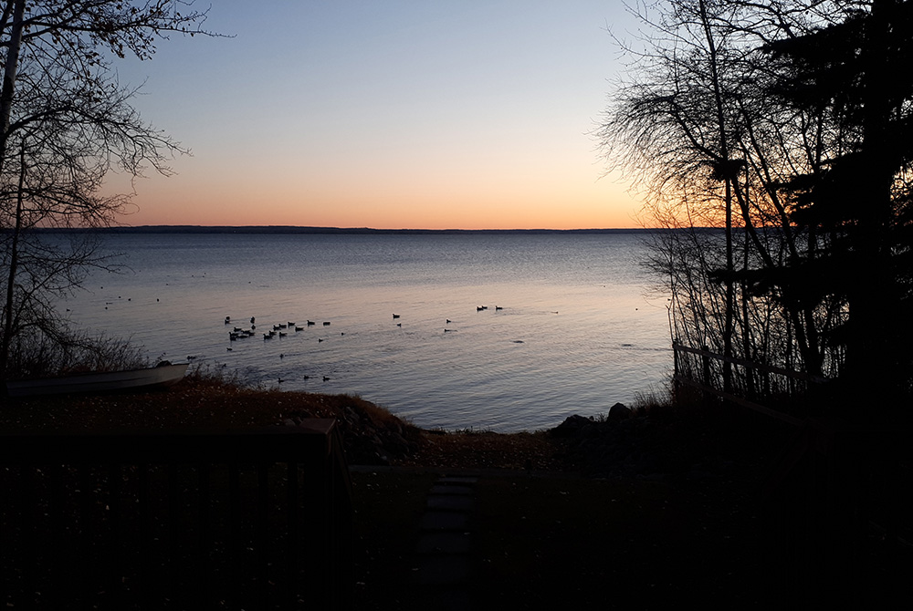 The birth of a day on an October morning in 2021, over a lake in Canada (Catherine Grasswill)