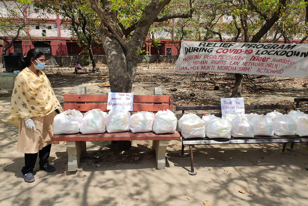 Sr. Rani Punnaserril, a member of the Sisters of the Holy Cross, with food packages for migrant workers (Provided photo)