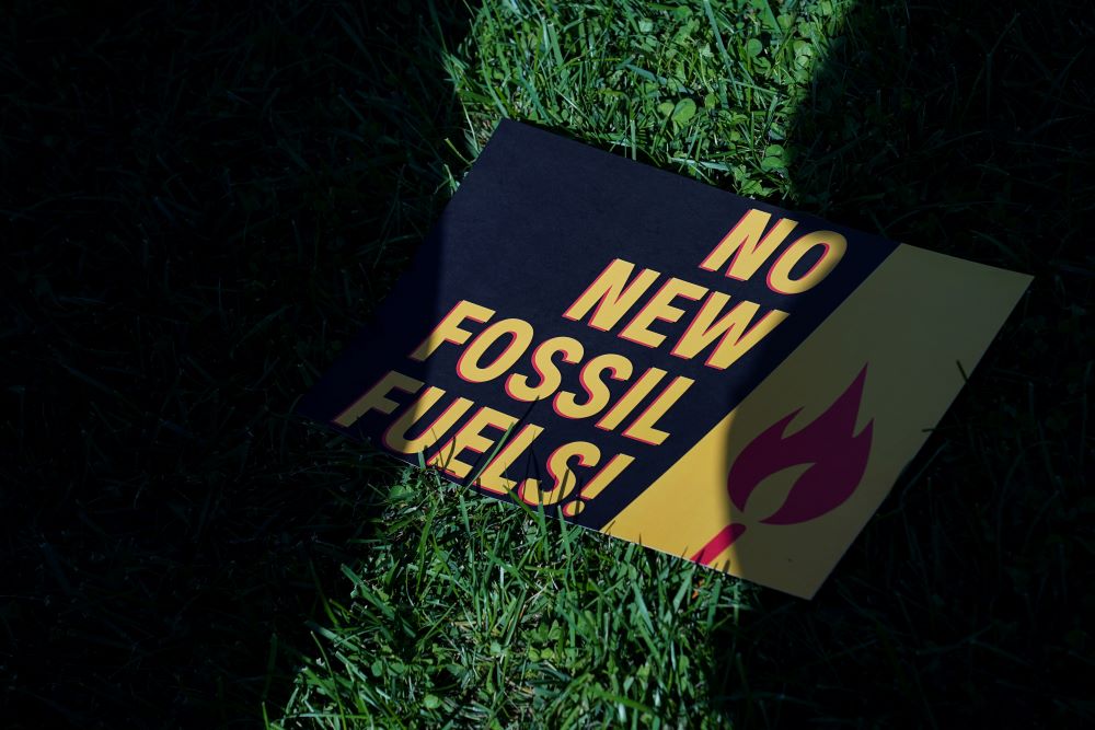 A sign protesting fossil fuels is seen on the lawn outside of the U.S. Capitol during a protest in Washington Oct. 18, 2019. (CNS/Reuters/Sarah Silbiger)