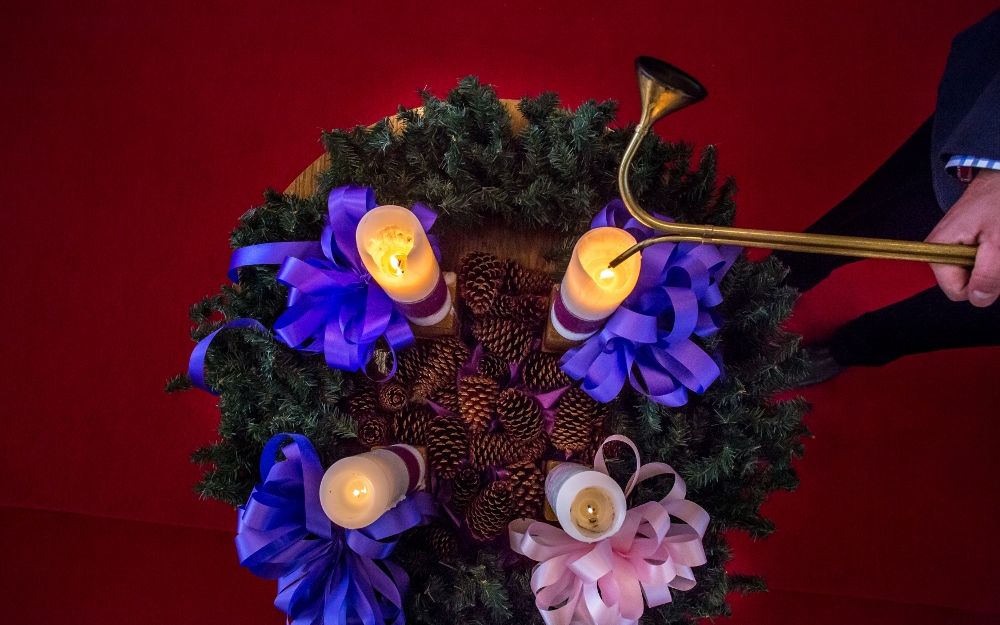 A man lights a candle on the Advent wreath at St. Raphael the Archangel Church in St. Louis in 2015. 