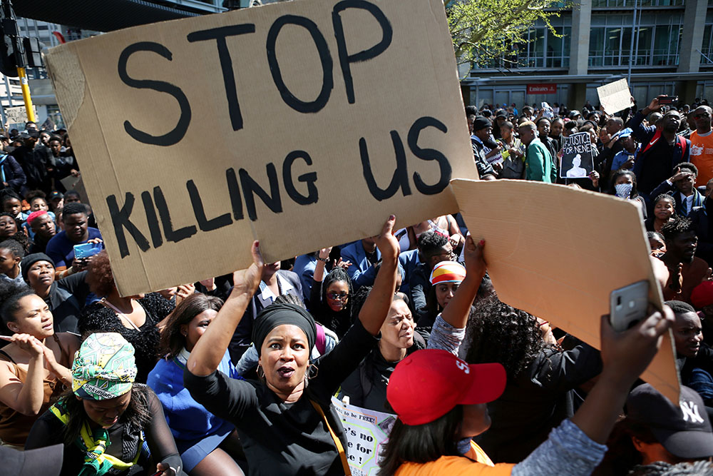 A woman holds a sign as demonstrators gather Sept. 4, 2019, at the World Economic Forum on Africa in Cape Town, South Africa, during a protest against gender-based violence. (CNS/Reuters/Sumaya Hisham)